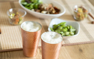 Copper tumblers on table