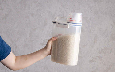 Holding the rice storage container filled with rice