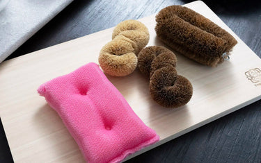 Sponge and brushes on cutting board