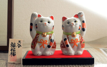 What is "Maneki-neko", a figure of a beckoning cat?