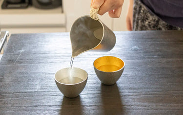 Pouring hot sake into cup