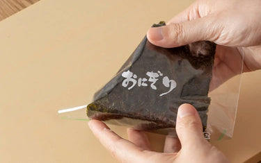 Wrapping onigiri with a Seinichi Onigiri Wrapper