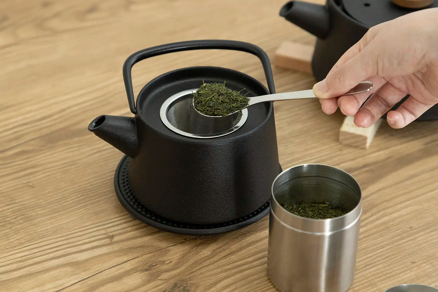 Placing tea leaves in teapot