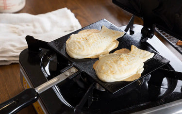 Two taiyaki in a taiyaki waffle iron