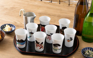 Cups half-filled with warm sake