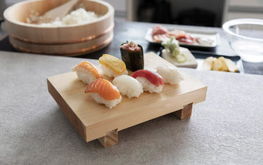 Several varieties of sushi on wooden plate