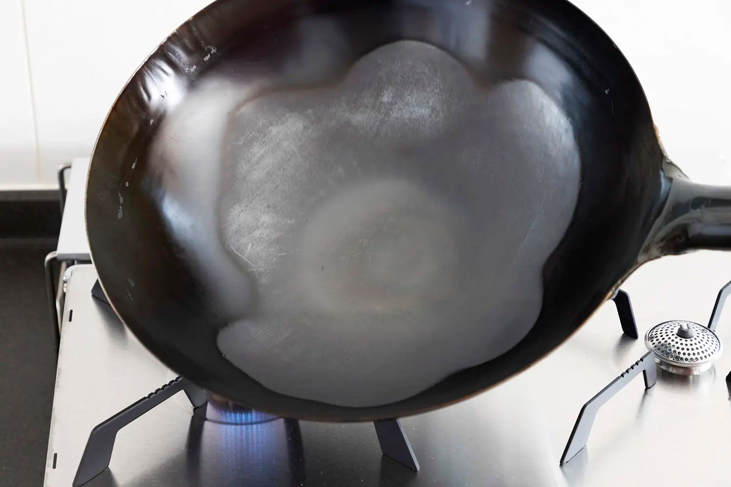 Burning off the anti-rust coating on a new wok
